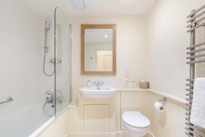 a bathroom with a toilet and a sink and a shower at Thyme Cottage in Eastdean +8 photos