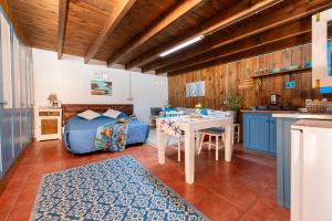 a kitchen with a bed and a table in a room at Cabin in front of idyllic majanicho beach in Majanicho