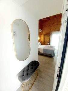 a mirror and a chair in a room with a bed at Divine Studios Elafonisos B2 in Elafonisos
