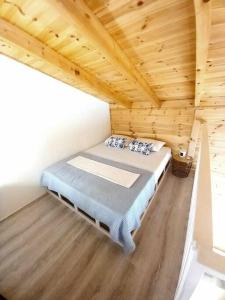 a bedroom with a bed in a wooden cabin at Divine Studios Elafonisos B2 in Elafonisos