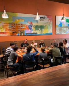 a group of people sitting at a table in a restaurant at ViaVia Buenos Aires GuestHouse in Buenos Aires +20 photos