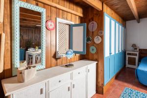 a room with a white cabinet and a mirror at Cabin in front of idyllic majanicho beach in Majanicho