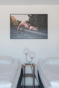 a picture of two dogs on a surfboard in a bedroom at Serviced Apartments Pirkkala by UHANDA in Tampere