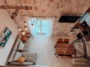 a view of a living room with a couch and a tv at STONE HOUSE JEZERA in Jezera