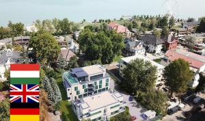 an aerial view of a city with a large house at Villa Bauhaus Wellness Apart-Hotel in Siófok
