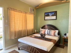 a bedroom with a bed with a bow on it at Panari Lodge El Nido in El Nido