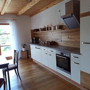 a kitchen with white cabinets and a stove top oven at Ferienwohnung Morgenrot in Pfronten