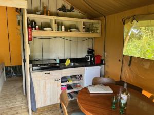 a kitchen with a wooden table and a table and a table and a tableablish at FF uutbloazen in Heelweg