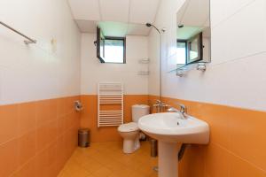 a bathroom with a sink and a toilet at Eco Hotel Imenieto in Emen +30 photos