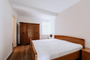 1 dormitorio con 1 cama y armario de madera en Perle im Mecklenburger Parkland, en Walkendorf