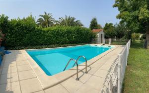 a swimming pool with a fence around it at Sweet Home - 55m2 appt, garden, swimming pool, parking in Toulouse