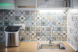 a kitchen with a sink and a tiled wall at Mamma's home in Trogir in Trogir +20 photos