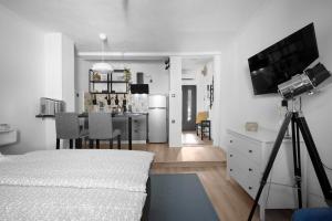 a bedroom with a camera on a tripod next to a kitchen at Mamma's home in Trogir in Trogir