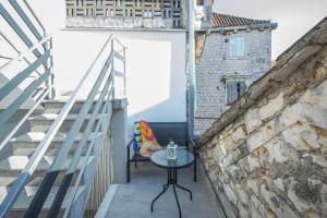a small table on the balcony of a building at Mamma's home in Trogir in Trogir