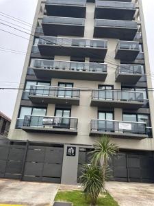 an apartment building with balconies on the side of it at Liniers, con vista al mar in Mar del Plata