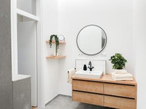 a bathroom with a sink and a mirror at My Baltic Sea - Ferienwohnungen im Saltwater House in Scharbeutz