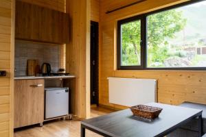 a kitchen with a table and a window in a room at Gorai in Kazbegi +16 photos