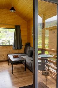 a living room with a couch and a table at Gorai in Kazbegi