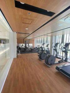 a gym with several treadmills and exercise bikes at At the Heart of Davao w/ Wifi, Netflix & Disney+ in Davao City