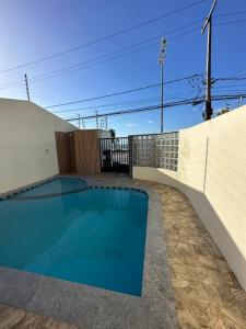 a swimming pool in the backyard of a house at Apês Completos na Litorânea l Cozinha e Conforto l Ferreira Hospedagens in São Luís