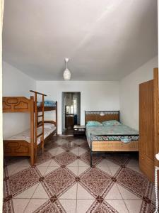 a bedroom with two beds and a bunk bed at Tony Home in Borsh +72 photos
