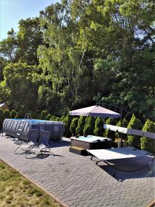 a patio with a table and chairs and an umbrella at Pokoje Gościnne Ontario Mieroszyno in Jastrzębia Góra