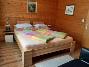 a bedroom with a bed in a wooden room at Ferienwohnungen Pollhammer in Sankt Gallenkirch