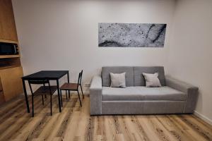 a living room with a couch and a table at Volcanic Boutique Hostel in Angra do Heroísmo