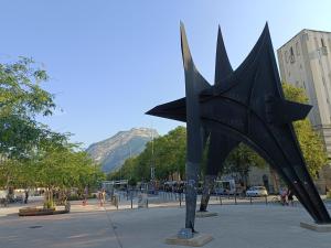 a statue of a black star in a city at Studio à la Gare&centre de Grenoble in Grenoble