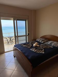 a bedroom with a bed with a view of the ocean at Renata Seaview Apartment 310 in Durrës