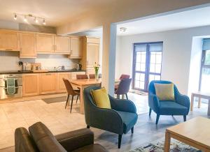 a kitchen and dining room with a table and chairs at Old Court Holiday Homes 3 Bed - Sleeps 6 in Terryglass