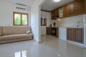 a living room with a couch and a kitchen at Panoramic Apartments Anić in Blato