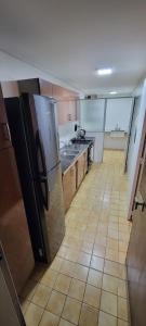a large kitchen with a tiled floor and appliances at Beautiful Apt on the Peatonal in Mendoza