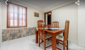 a dining room with a wooden table and chairs at Krohberger Residence Hostel in Pomerode +22 photos
