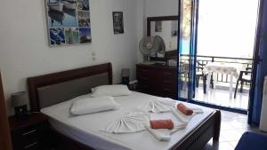 a bedroom with a bed with two towels on it at Kocheilas Studios in Gialiskari +40 photos