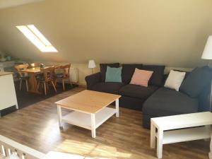 a living room with a couch and a table at Hof Lindemann in Schneverdingen