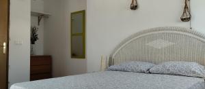 a bedroom with a white bed with a white headboard at Apartamento Centro Histórico materno infantil hospital civil in Málaga