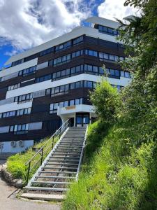 a large building with stairs in front of it at Studio cosy à vue Panoramique in Puy-Saint-Vincent