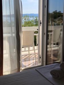 an open door to a patio with a chair on a balcony at Villa Gradina in Baška Voda