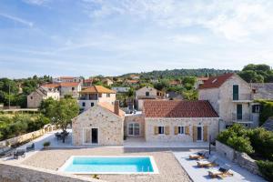 an exterior view of a villa with a swimming pool at Villa Olim Civitas in Škrip
