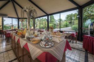 a large room with a table with food on it at San Martino Hotel Wellness in Riparbella