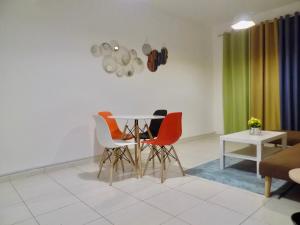 a dining room with a table and four chairs at Al Canary Aparts in Ajman 
