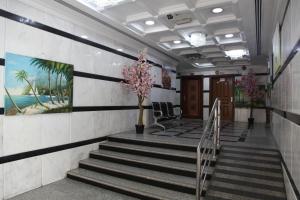 a lobby with stairs and a painting on the wall at Al Canary Aparts in Ajman 