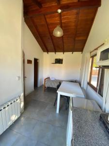 a kitchen with a table and a couch in a room at Complejo San Cristobal in Santa Clara del Mar