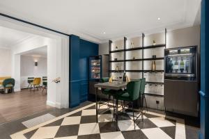 bar z niebieskimi ścianami i szachownicą w obiekcie Hôtel le Royal Rive Gauche w Paryżu