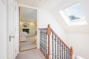 Una escalera que conduce a un dormitorio con ventana en Stable Cottage 2 bedrooms with gorgeous views, en Dunblane
