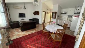 a kitchen and living room with a table and chairs at House in the Mountains near Budva in Budva