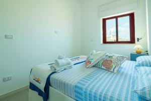 A bed or beds in a room at Appartamenti Craulo