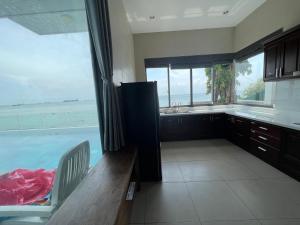 a kitchen with a large window and a swimming pool at Nancy Tran Grand Strip Vung Tau Villa 8 in Vung Tau