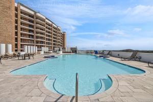 a large swimming pool on top of a building at Relax with a Fabulous Ocean View Ocean Sounds in This 2 Bedroom 2 Bath Den in Port Aransas